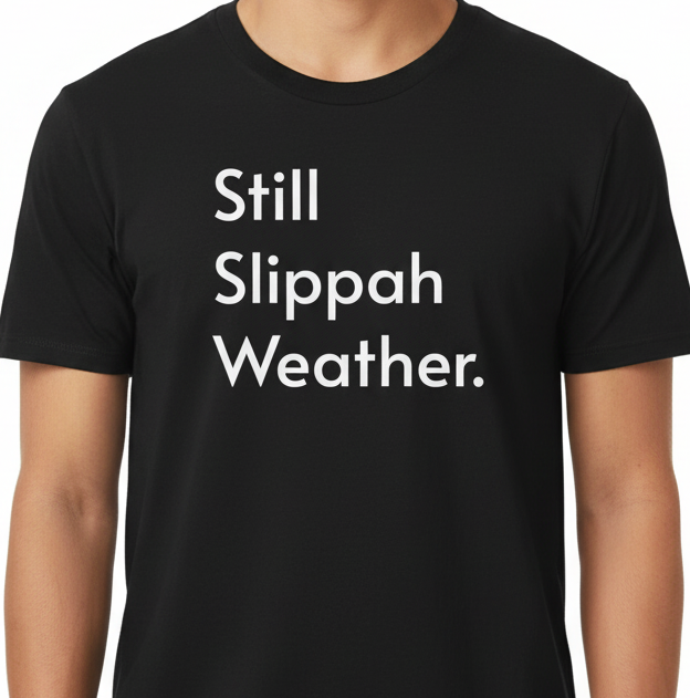 Black t-shirt with 'Still Slippah Weather' text worn by a person