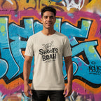 Beige t-shirt with 'Shoots Brah' text and hand gesture design on a white background