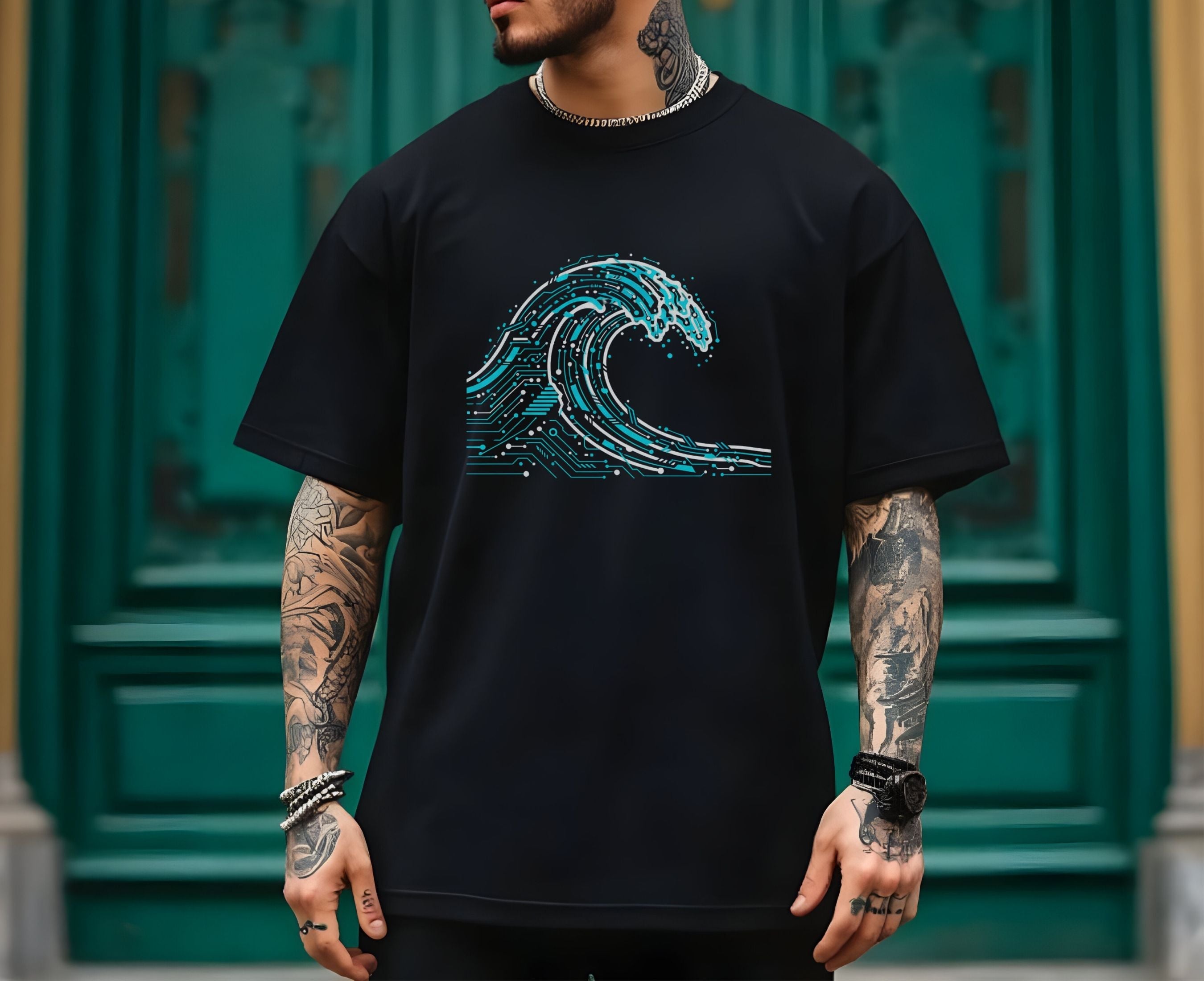 Person wearing a black t-shirt with a blue wave design in front of a green door.