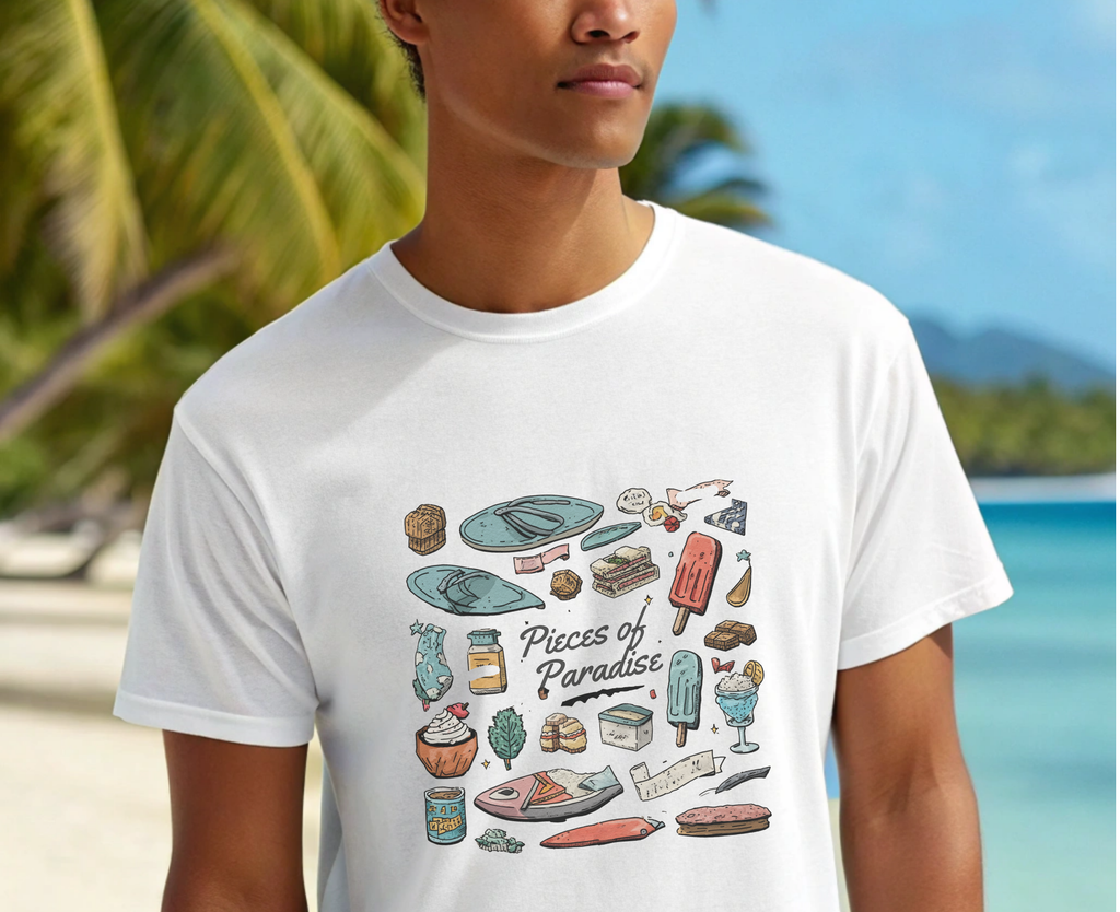 Person wearing a white t-shirt with 'Pieces of Paradise' graphic design, beach background
